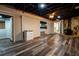 Open concept basement area with wood-look floors, fireplace and access to the kitchen at 5357 Highway 81, Loganville, GA 30052