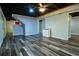 Finished basement with wood-look floors, painted walls, recessed lighting and ceiling fan at 5357 Highway 81, Loganville, GA 30052