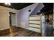 Wide open basement area has painted walls, dark wood-look floors, and access to multiple rooms at 5357 Highway 81, Loganville, GA 30052