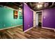 Bedroom featuring new flooring, bright purple walls, and a closet area at 5357 Highway 81, Loganville, GA 30052
