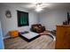 Bedroom with hardwood floors, natural light, and minimal furniture creating a blank canvas at 5357 Highway 81, Loganville, GA 30052