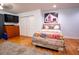 Bedroom featuring hardwood floors, a dresser, and a television at 5357 Highway 81, Loganville, GA 30052