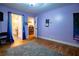 Bedroom with hardwood floors and purple walls with a view of the adjoining bathroom at 5357 Highway 81, Loganville, GA 30052