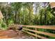 Spacious wooden deck with a built-in bench seating and grill overlooking the wooded backyard at 5357 Highway 81, Loganville, GA 30052