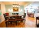 Sunlit dining room with wood floors and view to the kitchen at 5357 Highway 81, Loganville, GA 30052