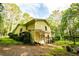 Rear exterior view of the home with a fenced yard and a glimpse of surrounding trees at 5357 Highway 81, Loganville, GA 30052