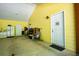 Interior of yellow garage with exterior door and space for multiple cars at 5357 Highway 81, Loganville, GA 30052