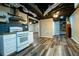 Open concept kitchen with updated appliances, subway tile, gas cooktop, stainless vent hood, and open ceiling at 5357 Highway 81, Loganville, GA 30052