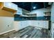 View of kitchen with subway tile backsplash, open shelving, gas cooktop, white cabinets and wood-look floors at 5357 Highway 81, Loganville, GA 30052