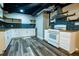Open concept kitchen with updated appliances, subway tile, gas cooktop, stainless vent hood and open shelving at 5357 Highway 81, Loganville, GA 30052