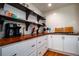 Bright kitchen features open shelving, wood countertops, and white cabinets at 5357 Highway 81, Loganville, GA 30052