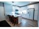 Kitchen with stainless appliances, white cabinets, island, and hardwood floors at 5357 Highway 81, Loganville, GA 30052