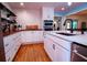 Bright kitchen with butcher block countertops, white cabinetry, and stainless appliances at 5357 Highway 81, Loganville, GA 30052