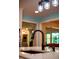 Modern kitchen island with stainless steel sink and faucet under mason jar light fixture at 5357 Highway 81, Loganville, GA 30052