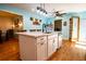 Open concept kitchen features an island with seating, stainless steel appliances, and pantry at 5357 Highway 81, Loganville, GA 30052