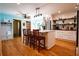 Open kitchen with island, hardwood floors, and stainless steel refrigerator at 5357 Highway 81, Loganville, GA 30052