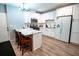 Modern kitchen with new floors, stainless appliances, white cabinets, and an island at 5357 Highway 81, Loganville, GA 30052