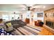 Inviting living room featuring a brick fireplace, ceiling fans and hardwood floors at 5357 Highway 81, Loganville, GA 30052