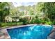 Beautiful in-ground pool with landscaped surroundings and a yellow home exterior, creating a serene backyard setting at 5357 Highway 81, Loganville, GA 30052