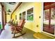 Close-up of covered porch with rocking chairs and wood trim at 5357 Highway 81, Loganville, GA 30052
