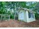 Exterior view of a charming shed featuring classic design with white trim and a sturdy door perfect for storage or workshop at 5357 Highway 81, Loganville, GA 30052