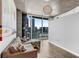 Bright living room features city views, hardwood floors, and a modern lighting fixture at 860 Peachtree Ne St # 1806, Atlanta, GA 30308
