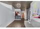 Open living area with modern lighting, island seating, and hardwood floors throughout at 860 Peachtree Ne St # 1806, Atlanta, GA 30308