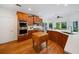 Bright kitchen with wood cabinets, stainless appliances, an island, and hardwood floors at 295 River Laurel Way, Woodstock, GA 30188