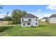A view of the home's backyard and white exterior from a low angle at 320 Aspen Valley Dr, Loganville, GA 30052