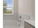 Bathtub with marble tile and countertops in the primary bathroom at 320 Aspen Valley Dr, Loganville, GA 30052