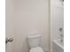 Bright bathroom featuring a toilet and a shower-tub combination with white tiles at 320 Aspen Valley Dr, Loganville, GA 30052