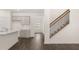 Spacious living area showcases kitchen, entryway, stairs, and hardwood flooring at 320 Aspen Valley Dr, Loganville, GA 30052