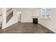 Spacious living room with a staircase, fireplace, and large window at 320 Aspen Valley Dr, Loganville, GA 30052