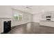 Open living area with fireplace, hardwood floors, view of the kitchen, and a double door at 320 Aspen Valley Dr, Loganville, GA 30052
