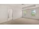 Spacious main bedroom with carpet, ceiling fan and natural light from the two windows overlooking the front yard at 320 Aspen Valley Dr, Loganville, GA 30052