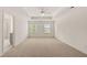 Large main bedroom with tray ceiling, carpeted floors, and two windows at 320 Aspen Valley Dr, Loganville, GA 30052