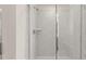 Beautiful tiled walk-in shower with frameless glass doors at 320 Aspen Valley Dr, Loganville, GA 30052