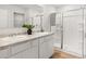 This spacious bathroom has a double sink with white cabinetry, a glass shower, and tiled floors at 414 Oak View Ln, Dallas, GA 30157