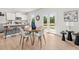 Sunlit dining area features a modern table set near the bright and open kitchen space at 414 Oak View Ln, Dallas, GA 30157