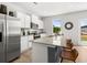 Kitchen features a large island with bar seating, stainless appliances, and modern lighting at 414 Oak View Ln, Dallas, GA 30157