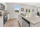 Open kitchen with stainless steel appliances, island with sink, and natural light at 414 Oak View Ln, Dallas, GA 30157