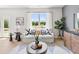 Bright living room featuring plush sofa, stylish decor and large window with natural light at 414 Oak View Ln, Dallas, GA 30157