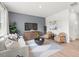 The comfortable living room features a plush sofa, modern decor, and a view of the entry at 414 Oak View Ln, Dallas, GA 30157