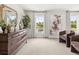 Bright main bedroom features a large dresser, windows, modern decor, and plush carpet at 414 Oak View Ln, Dallas, GA 30157
