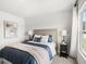 The main bedroom has a cozy bed, natural light from a window, and decorative pillows at 414 Oak View Ln, Dallas, GA 30157