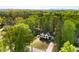 Beautiful home with black trim, white siding, black painted brick, surrounded by mature trees at 4201 Brookview Se Dr, Atlanta, GA 30339