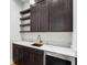 Wet bar with custom cabinets, open shelves, a stone countertop, and a stainless steel refrigerator at 4201 Brookview Se Dr, Atlanta, GA 30339