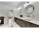 Primary bathroom with double sinks, marble countertops, and a door to the bedroom at 4201 Brookview Se Dr, Atlanta, GA 30339