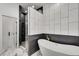 This primary bathroom features a soaking tub, glass shower, and modern tiling at 4201 Brookview Se Dr, Atlanta, GA 30339