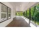 A spacious covered deck with wood flooring, black railing, and recessed lights, perfect for outdoor relaxation at 4201 Brookview Se Dr, Atlanta, GA 30339